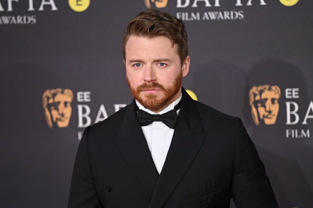 Jack Lowden at the Baftas wearing a black tuxedo