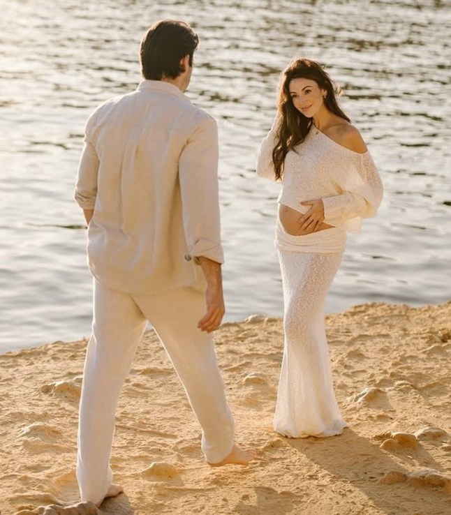 A compilation image of Michelle Keegan cradling her bump in a white dress, and with Mark Wright in a white suit on a beach