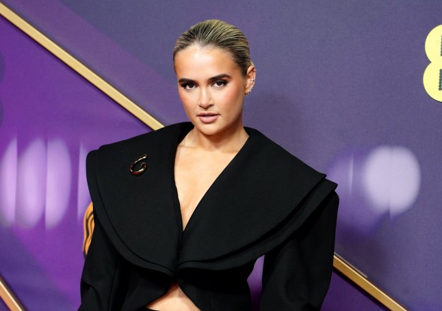 Molly-Mae Hague posing at the attending the 2025 BAFTAs.