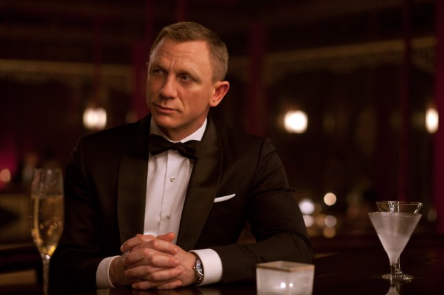 Daniel Craig as James Bond in Skyfall. He is wearing a black tuxedo and sitting at a bar with a martini