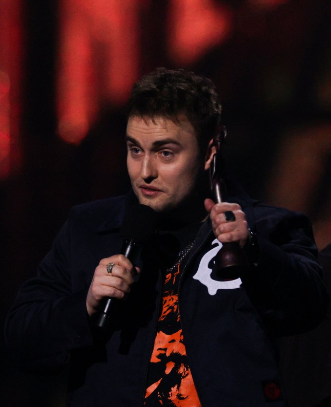 British singer and musician Sam Fender celebrates on stage after receiving the award for Alternative/Rock act during the BRIT Awards 2025 in London on March 1, 2025. (Photo by Adrian DENNIS / AFP) / RESTRICTED TO EDITORIAL USE NO POSTERS NO MERCHANDISE NO USE IN PUBLICATIONS DEVOTED TO ARTISTS (Photo by ADRIAN DENNIS/AFP via Getty Images)