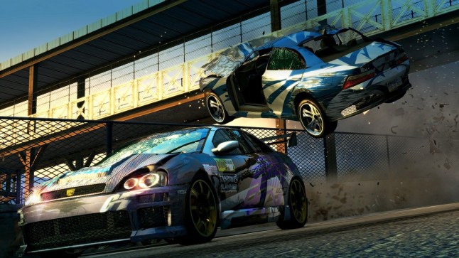 Burnout Paradise Remastered a racecar drives under another car that's crashing through the air