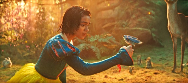 Rachel Zegler as Snow White holds a bird on her finger in a scene from Snow White