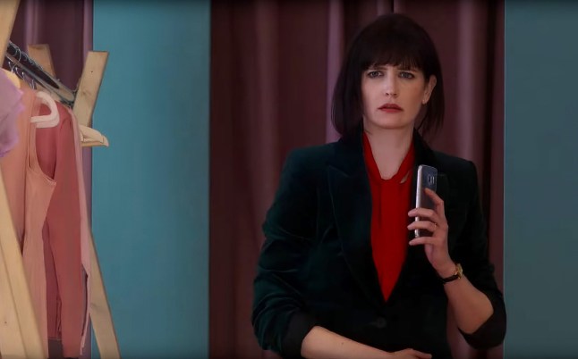 Eva Green looking deeply concerned as she holds her phone in a Nocebo scene.