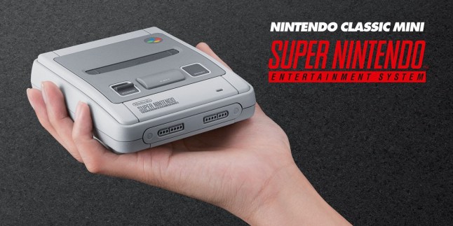 SNES Mini console being held in someone's hand