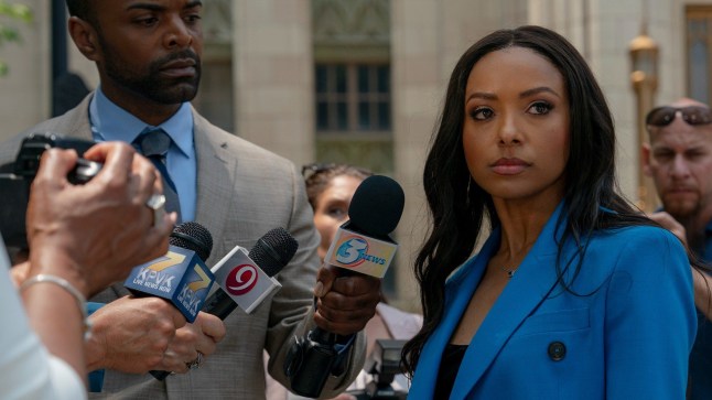 Kat Graham as Marley is questioned by press outside the courthouse in the film Duplicity