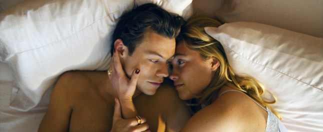 Harry Styles, Florence Pugh, lying in bed in the film Don't Worry Darling