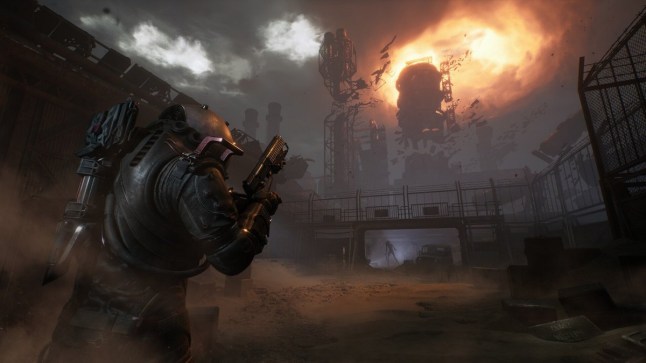 Cronos the New Dawn main character in space armour walking towards ruined buildings in wasteland