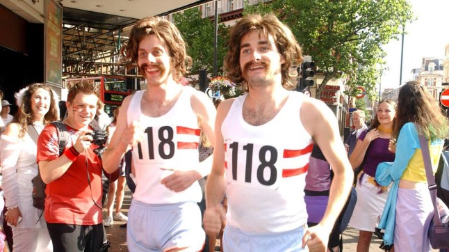 COLIN CARMICHAEL AND LUKE LANGSDALE DRESSED AS RUNNERS WITH 70S-STYLE HAIR AND MOUSTACHES PROMOTING 118 DIRECTORY ENQUIRIES LINE IN LONDON