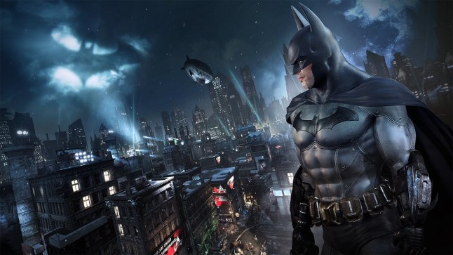 A Batman Arkham City screenshot depicting Batman standing on city rooftops while the bat signal shines in the sky