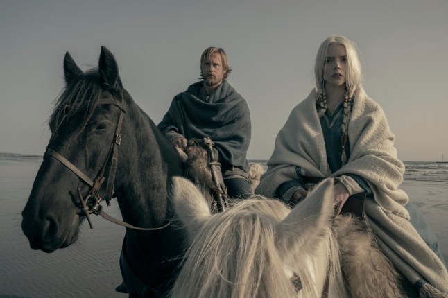 This image released by Focus Features shows Alexander Skarsg??rd, left, and Anya Taylor-Joy in a scene from "The Northman." (Aidan Monaghan/Focus Features via AP)