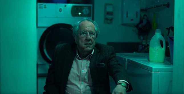 Geoffrey Rush as Stefan Mortensen in The Rule of Jenny Pen. He is sat in a room in front of a washing machine and appears scared