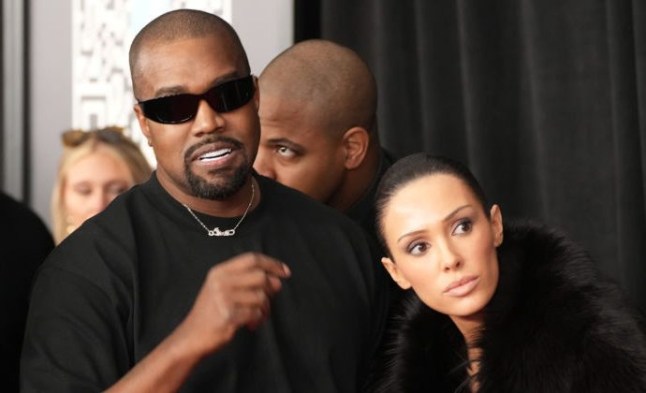 Kanye West and Bianca Censori on the red carpet. She wears fur coat and he wears black t0shirt.
