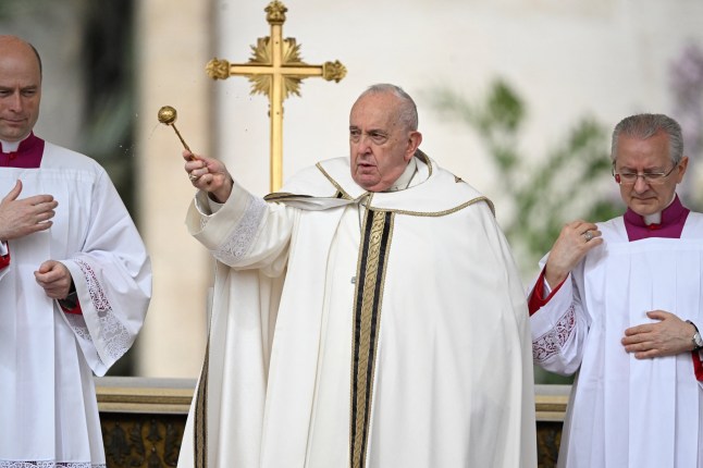 Pope Francis blesses the crowd as he presides over the Easter Mass as part of the Holy Week celebrations, at St Peter's square in the Vatican on March 31, 2024. (Photo by Tiziana FABI / AFP) (Photo by TIZIANA FABI/AFP via Getty Images)