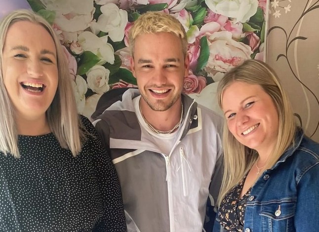 Nicola Payne, Liam Payne and Ruth Gibbins standing in front of a floral wall.