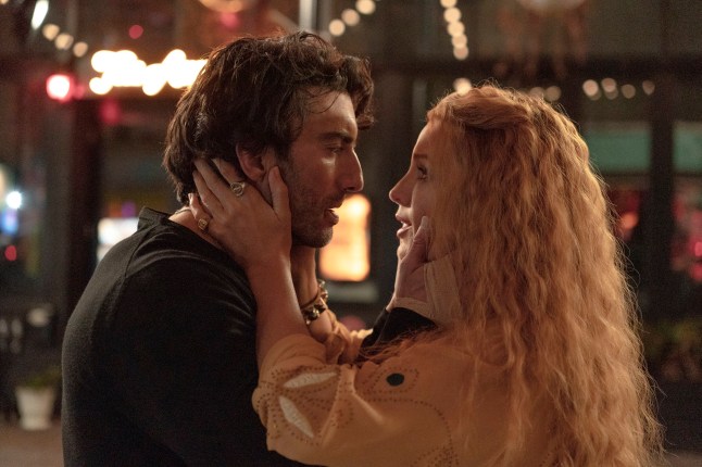 Justin Baldoni and Blake Lively in a scene from It Ends With Us, holding each other's faces.