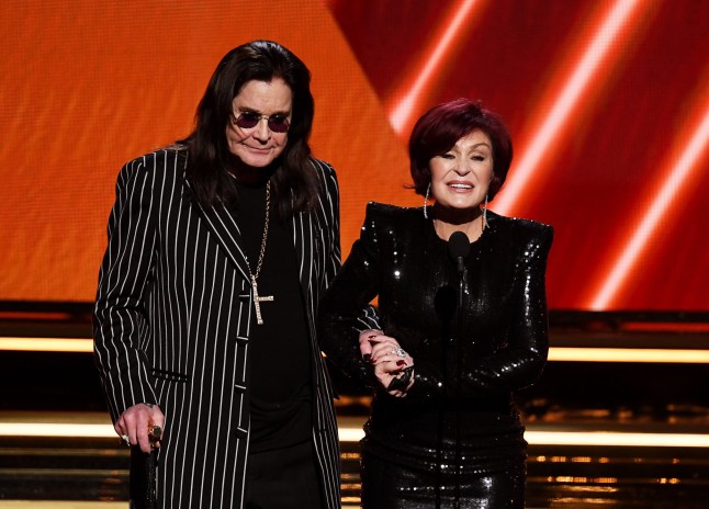 Ozzy Osbourne and Sharon Osbourne on stage in black suits