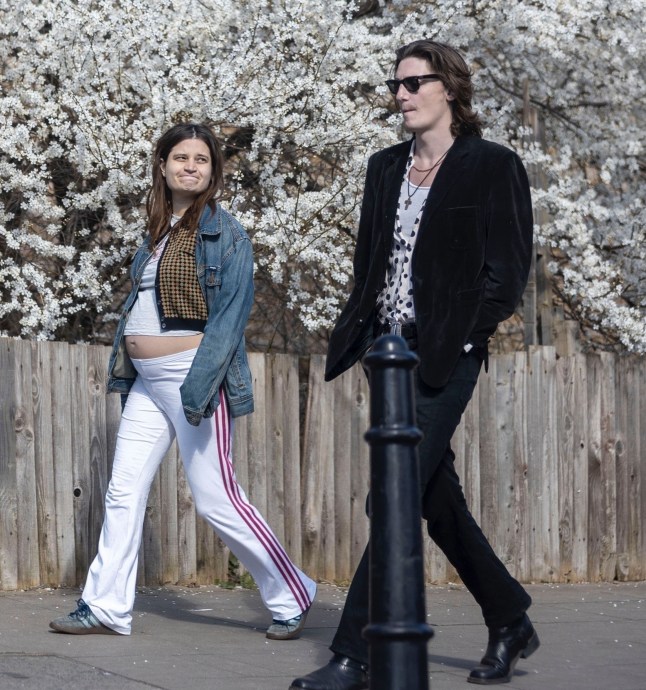BGUK_3188302 - *PREMIUM-EXCLUSIVE* London, UNITED KINGDOM - MUST CALL FOR PRICING BEFORE USAGE - STRICTLY NOT AVAILABLE FOR ONLINE USAGE UNTIL FURTHER NOTICE - The daughter of the late INXS frontman Michael Hutchence and the late British television presenter Paula Yates, Tiger Lily Hutchence and boyfriend Ben Archer are seen strolling through London enjoying the spring sunshine. Showing off her blossoming baby bump out in the spring-like conditions Tiger Lily is expecting her first child with Ben after dating the British model Ben since June 2023. Tiger went casual during the jaunt wearing her denim jacket, top and joggers and went stylish wearing her designer Vivienne Westwood handbag. Pictured: Tiger Lily - Ben Archer BACKGRID UK 20 MARCH 2025 UK: +44 208 344 2007 / uksales@backgrid.com USA: +1 310 798 9111 / usasales@backgrid.com *Pictures Containing Children Please Pixelate Face Prior To Publication*