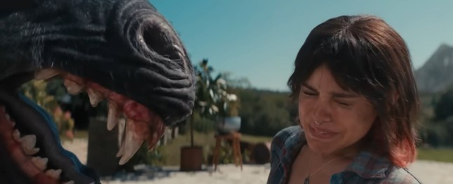 Jenna Ortega recoils from the jaws of a black unicorn in Death Of A Unicorn