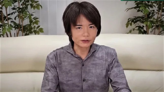 Masahiro Sakurai sitting on a white sofa