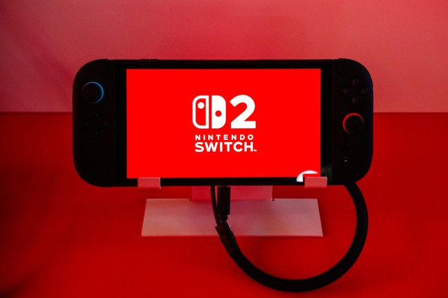 This photograph shows a Nintendo Switch 2 video-game console system of Japanese video-game company Nintendo, displayed during the worldwide presentation at the Grand Palais in Paris on April 2, 2025. Japanese video game giant Nintendo announced on April 2, 2025, that the new version of its Switch console would be launched on June 5, 2025. The Kyoto-based company also revealed new features for the Switch 2 -- an update to the 2017 original model -- including a new chat button that allows players to speak with each other while playing. (Photo by Dimitar DILKOFF / AFP) (Photo by DIMITAR DILKOFF/AFP via Getty Images)
