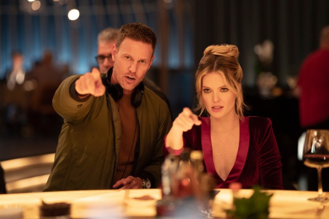 This image released by Universal Pictures shows director Christopher Landon, left, and Meghann Fahy in a scene from "Drop." (Universal Pictures via AP)