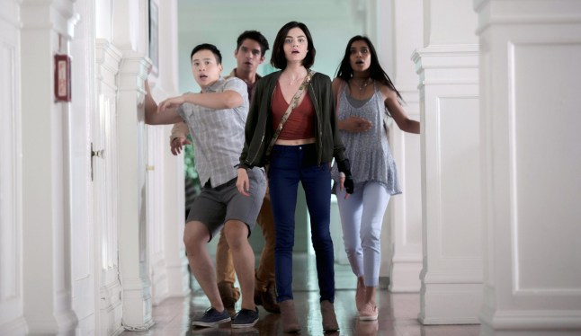 Hayden Szeto, Tyler Posey, Lucy Hale and Sophia Ali all recoil in horror from something in a white-paneled room in Truth or Dare
