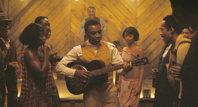 This image released by Warner Bros Pictures shows Miles Caton, center, in a scene from "Sinners." (Warner Bros. Pictures via AP)