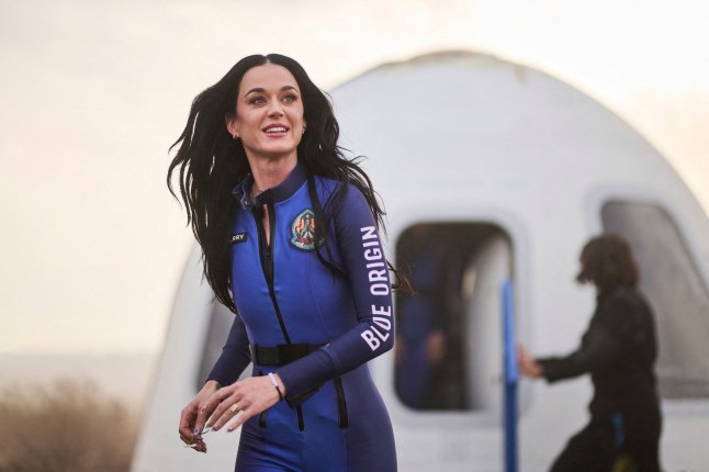 This handout photo from Blue Origin shows US singer Katy Perry upon return to Earth after a flight on Blue Origin New Shepard NS-31, which brought the passengers beyond the Karman line -- the internationally recognized boundary of space, in Van Horn, West Texas, April 14, 2025. Pop star Katy Perry completed a brief foray into space Monday, roaring to the edge of the cosmos with an all-women crew on one of billionaire Jeff Bezos's rockets. The "Firework" and "California Gurls" singer was lofted more than 60 miles (100 kilometers) above the Earth's surface in a vessel from Blue Origin, the space company owned by the Amazon founder. Five other women -- including Bezos's fiancee Lauren Sanchez -- were on the flight, which took off from western Texas shortly after 8:30 am (1330 GMT) before safely landing again some (Photo by Handout / BLUE ORIGIN / AFP) / RESTRICTED TO EDITORIAL USE - MANDATORY CREDIT "AFP PHOTO / HANDOUT / BLUE ORIGIN " - NO MARKETING NO ADVERTISING CAMPAIGNS - DISTRIBUTED AS A SERVICE TO CLIENTS (Photo by HANDOUT/BLUE ORIGIN/AFP via Getty Images)