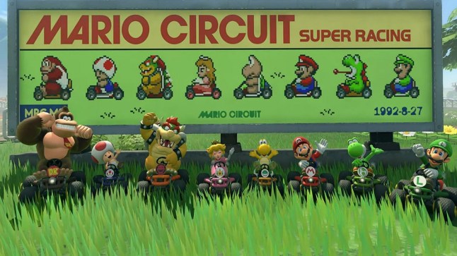 Mario Kart World characters lined up and posing in front of a sign featuring sprite from Super Mario Kart