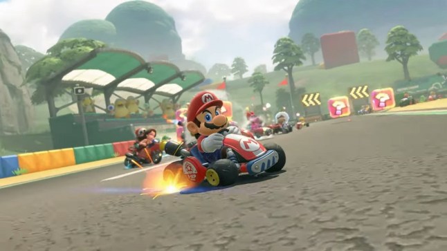A Mario Kart World screenshot featuring Mario on a kart racing around a track.