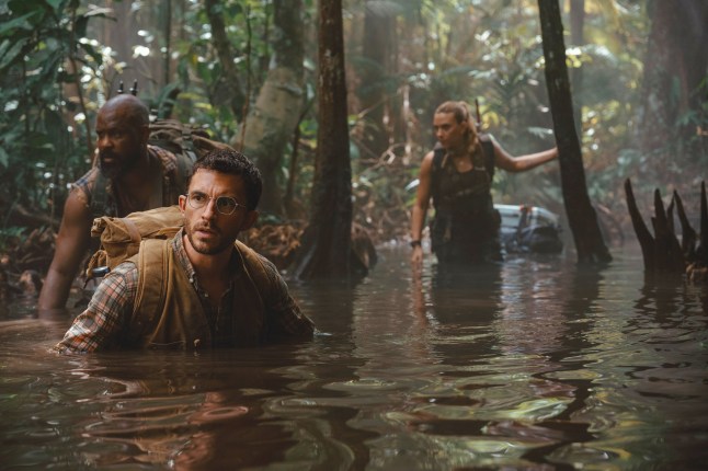This image released by Universal Pictures and Amblin Entertainment shows, from left, Bechir Sylvain, Jonathan Bailey, and Scarlett Johansson in a scene from " Jurassic World Rebirth." (Jasin Boland/Universal Pictures and Amblin Entertainment via AP)