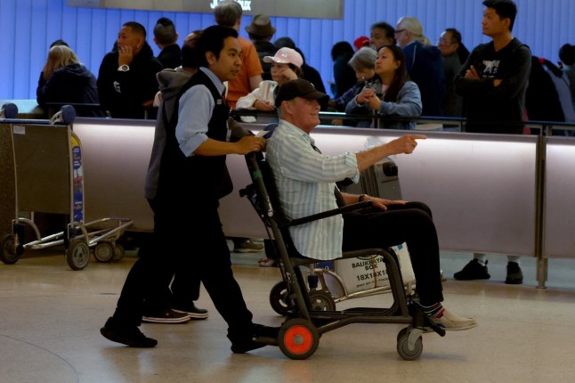 BGUK_3230967 - *PREMIUM-EXCLUSIVE* Los Angeles, CA - *MUST CALL FOR PRICING BEFORE USAGE* *STRICTLY NOT AVAILABLE FOR ONLINE USAGE UNTIL 01:00AM UK TIME ON 08/05/2025* David Hasselhoff is spotted in a wheelchair at LAX. The Hoff was arriving to California from Mexico with his wife Hayley Roberts. Wearing a striped shirt and baseball cap, David was wheeled through the terminal by an airpot worker to where his limo driver was waiting. He then eased out of the chair to walk the rest of the way, leaning heavily on Hayley. The 'Baywatch' star was eager to give the thumbs up and reassure waiting photographers he was okay, explaining that he needed a knee operation. *PICTURES TAKEN ON THE 05/05/2025* Pictured: David Hasselhoff, Hayley Roberts BACKGRID UK 7 MAY 2025 UK: +44 208 344 2007 / uksales@backgrid.com USA: +1 310 798 9111 / usasales@backgrid.com *Pictures Containing Children Please Pixelate Face Prior To Publication*