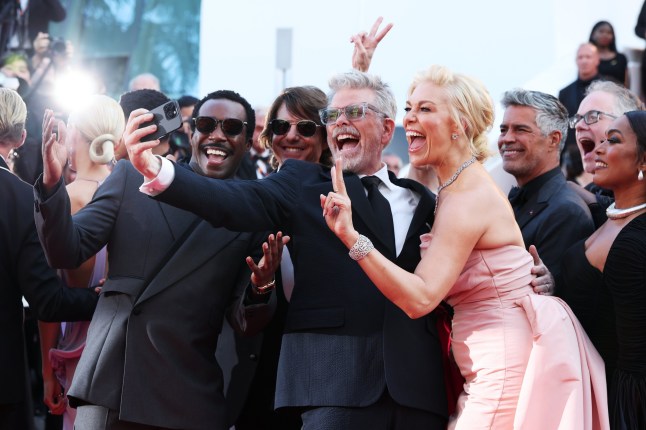 CANNES, FRANCE - MAY 14: (L-R) Tramell Tillman, Tom Cruise, Christopher McQuarrie, Hannah Waddingham, Esai Morales and Angela Bassett take a selfie on the "Mission Impossible - The Final Reckoning" red carpet at the 78th annual Cannes Film Festival at Palais des Festivals on May 14, 2025 in Cannes, France. (Photo by Gisela Schober/Getty Images)